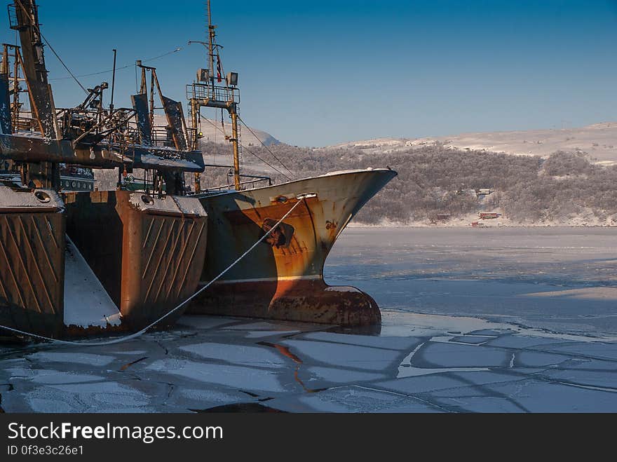 An old ship in the ice in the harbor int the winter. An old ship in the ice in the harbor int the winter.