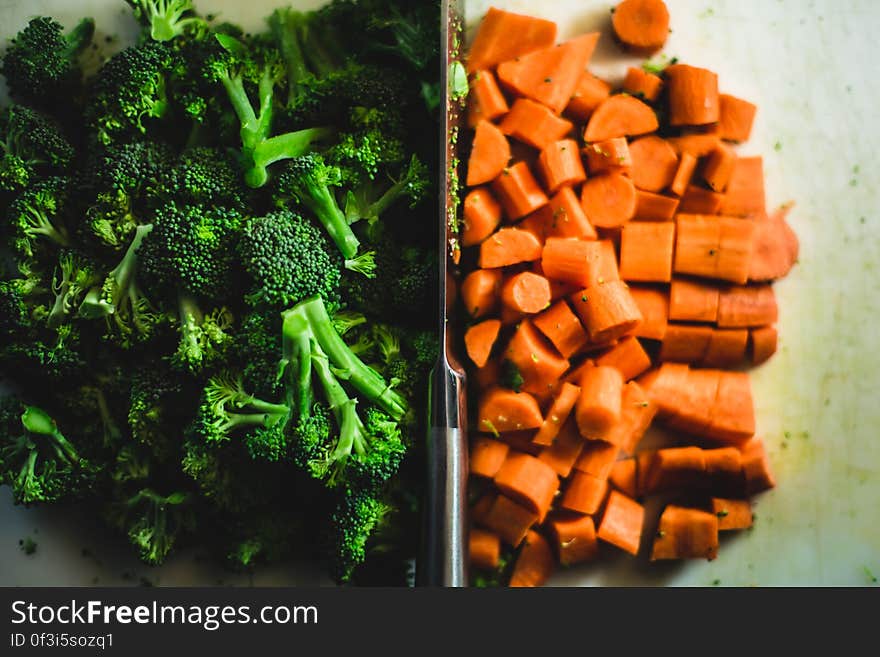 A portion of fresh broccoli and chopped carrots. A portion of fresh broccoli and chopped carrots.