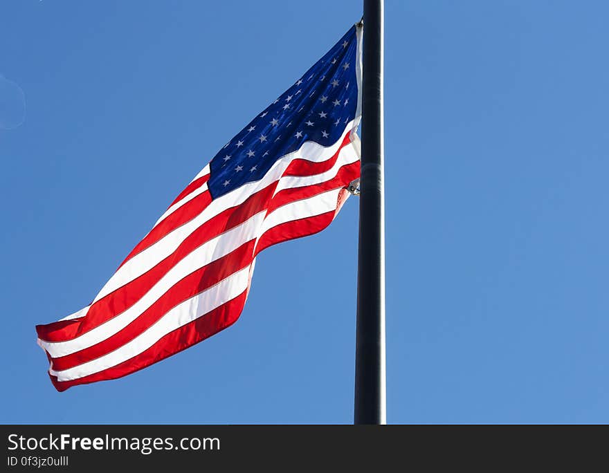 Low Angle View of Flag Against Blue Sky