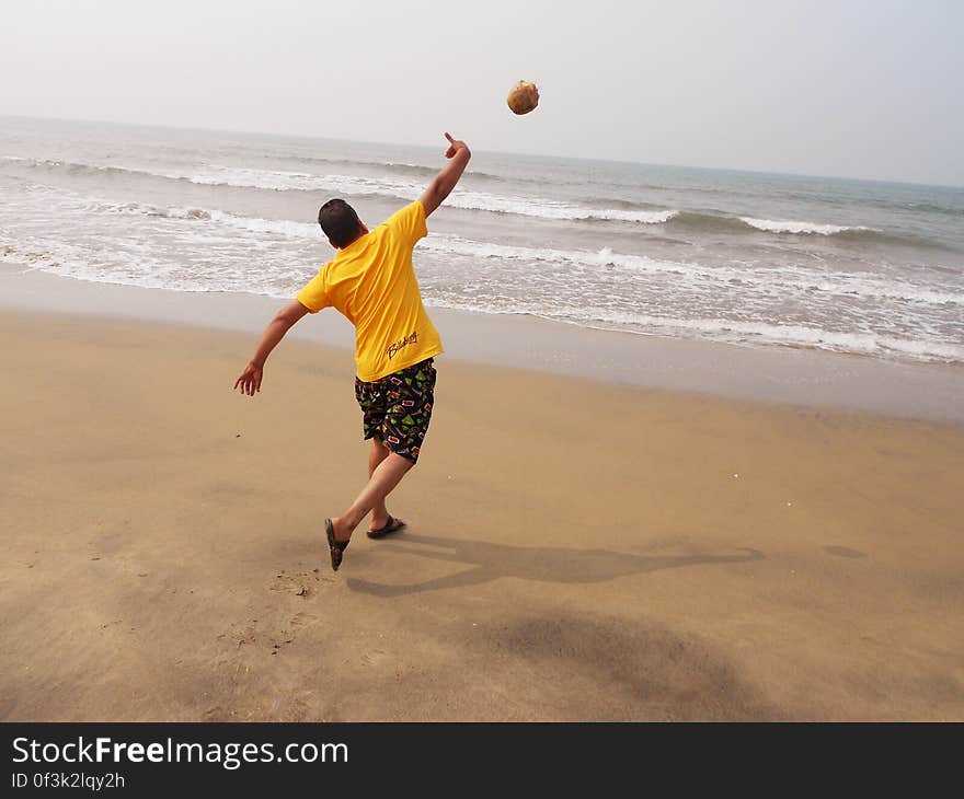 Guy throwing coconut in sea