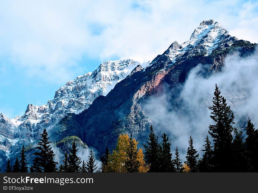 Snowy mountain peaks and conifer forests below.