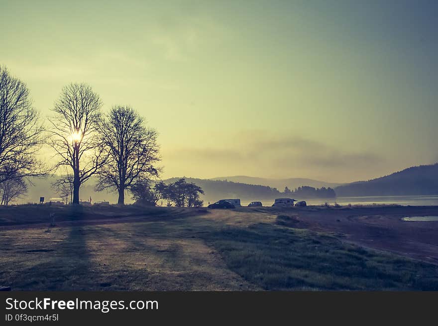 A campsite in the morning with camper vans and cars parked. A campsite in the morning with camper vans and cars parked.