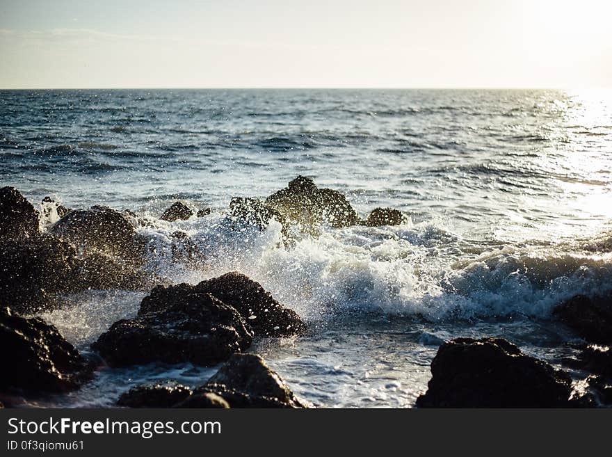 Photo of Blue Ocean Wave Coming to the Rocky Shore