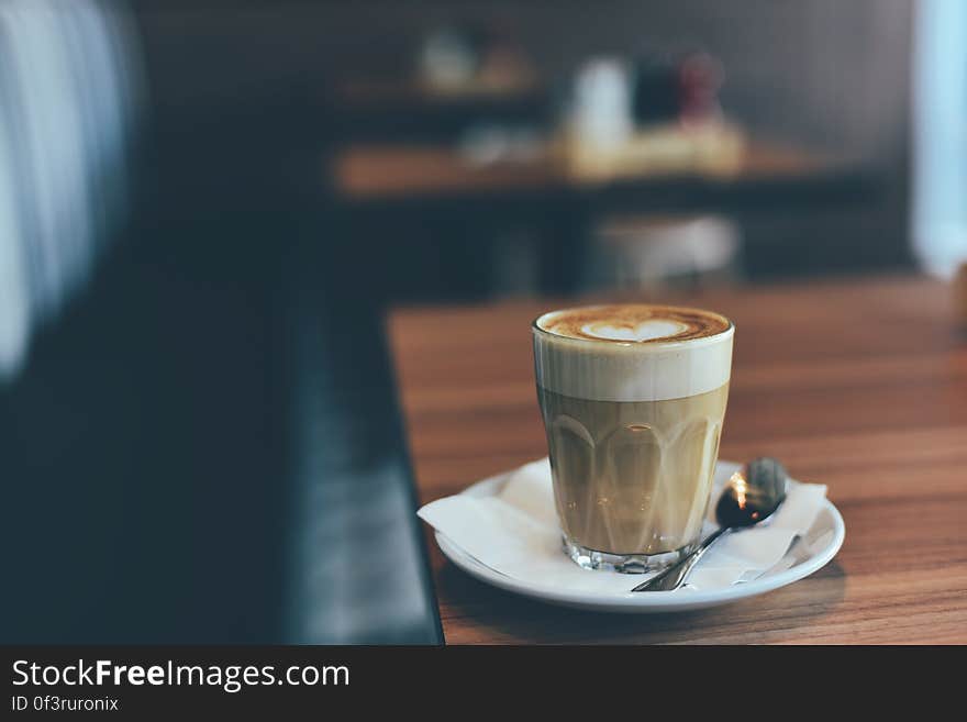 A glass of coffee with latte art decoration.