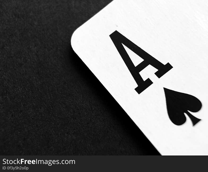 A close up of an ace playing card on a black background.