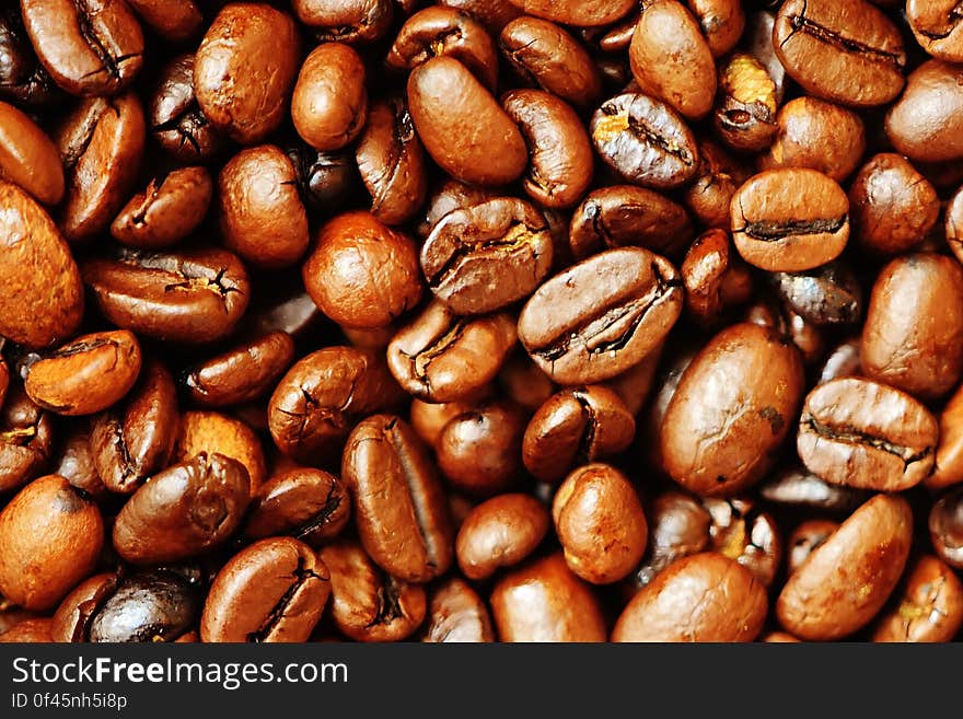 Background of brown dry roasted coffee beans.