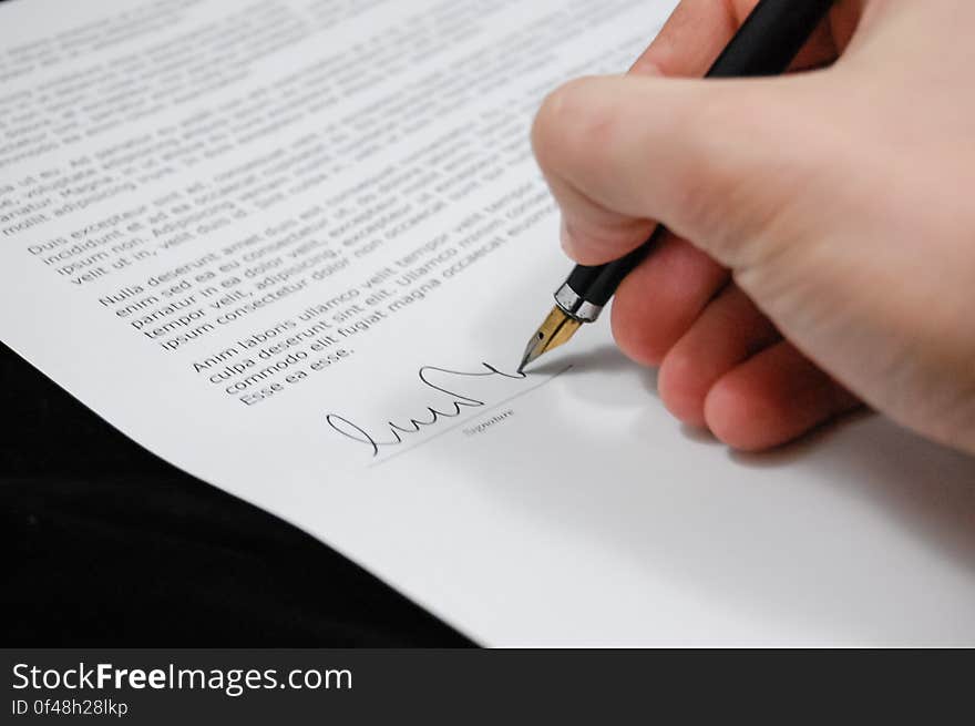 Person Signing in Documentation Paper