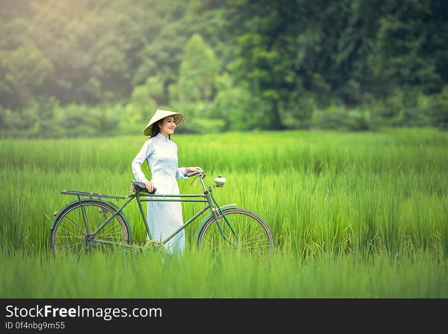 Woman With Bicycle on Grass