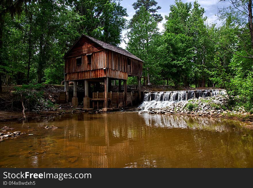 Landscape Photography of Brown Wooden House on Forest Near River