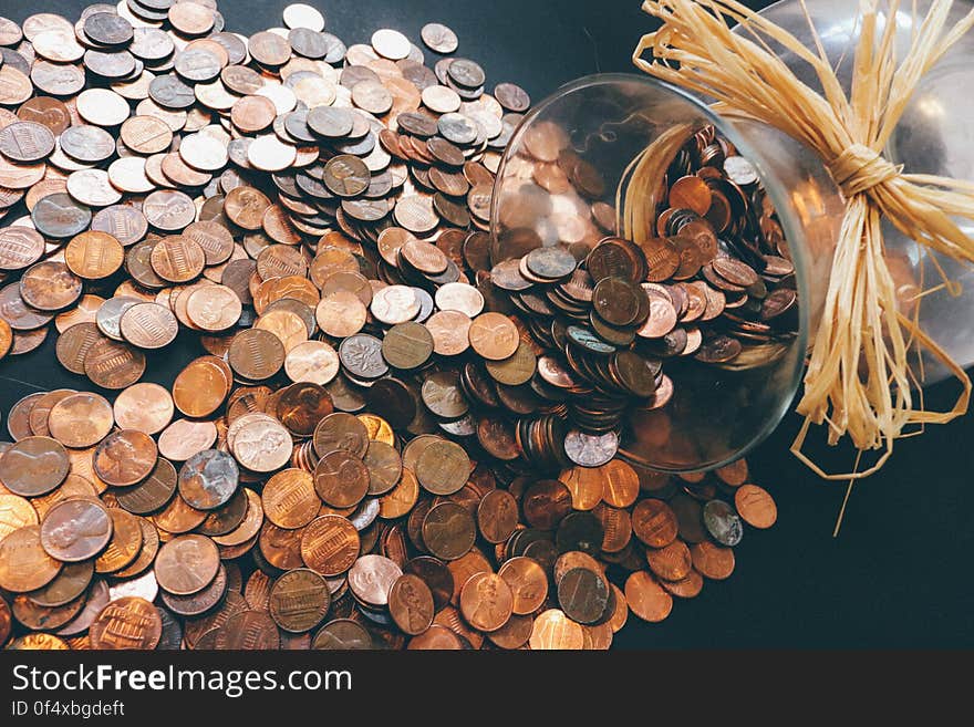 A toppled over jar of pennies. A toppled over jar of pennies.