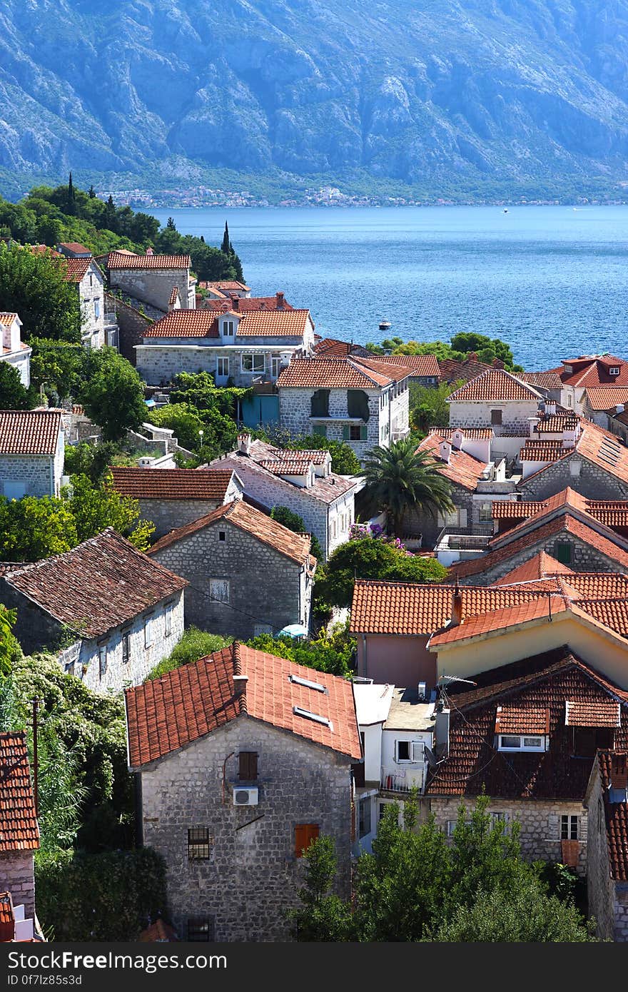 Top View Of Red Tiled Roofs And Courtyards In A Small Town In Montenegro, Tourists