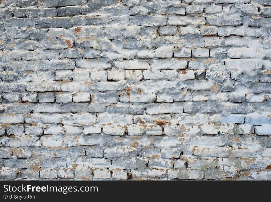 Cracked grunge brick wall textured background. Cracked grunge brick wall textured background
