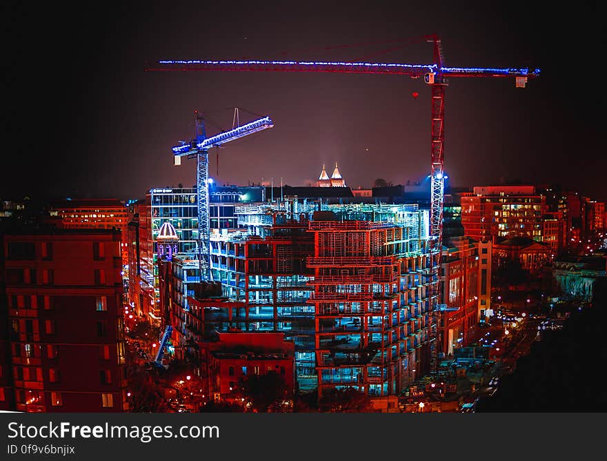 The glowing blue of lights left on at an inactive construction site in Washington, DC contrasts with the dim red hue of the city at night. Dedicated to the public domain with a CC0 license. The glowing blue of lights left on at an inactive construction site in Washington, DC contrasts with the dim red hue of the city at night. Dedicated to the public domain with a CC0 license.