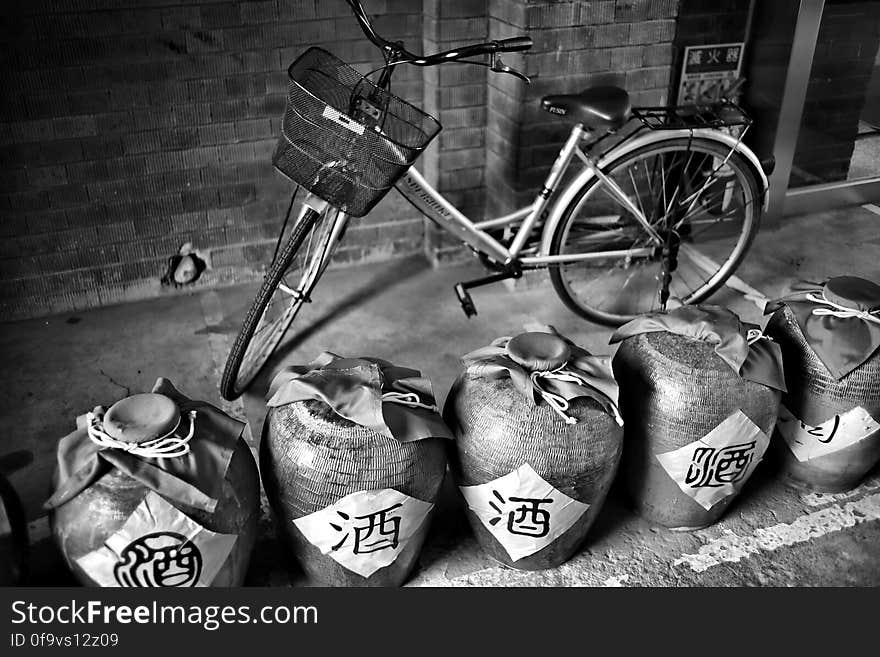 Grayscale Photography of Dutch Bike Behind Jars