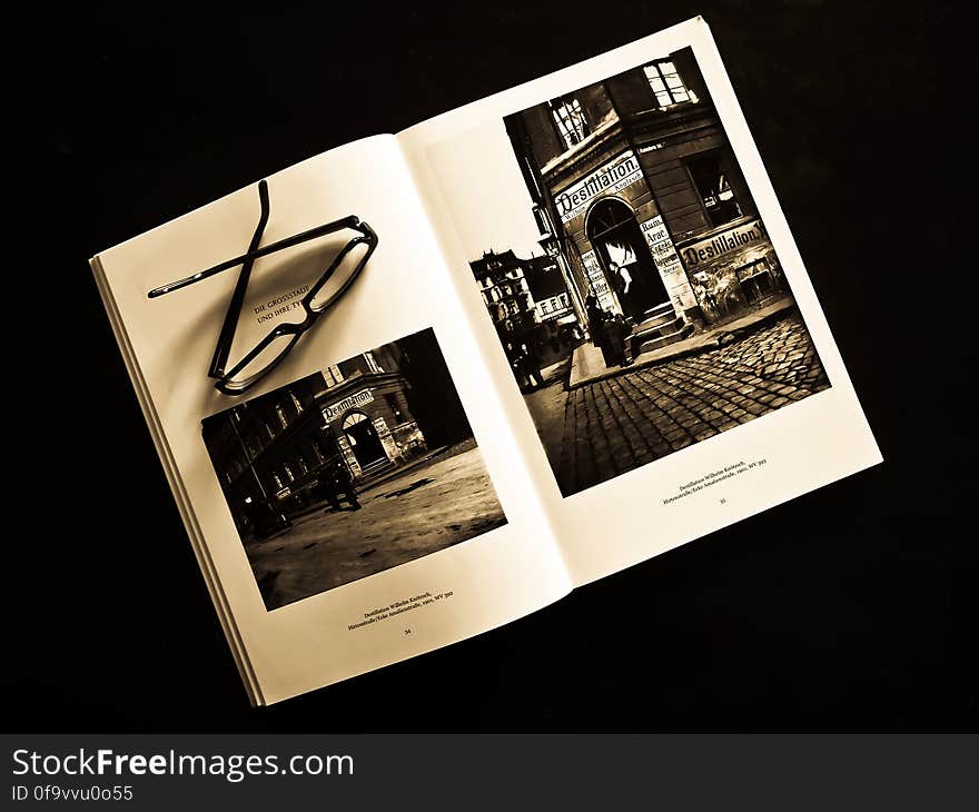 Black Framed Eyeglasses on White Photo Album