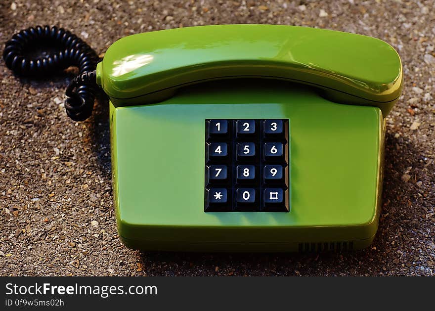 An old table phone with push buttons. An old table phone with push buttons.