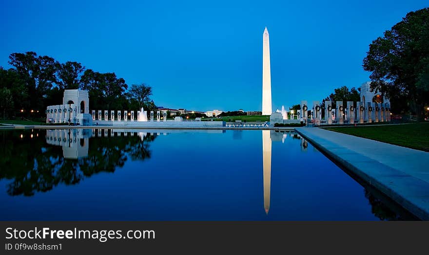 Reflection of Washington Monument through the Pacific WWII Memorial in the Reflecting Pool on the Mall of Washington, DC, USA at night. Reflection of Washington Monument through the Pacific WWII Memorial in the Reflecting Pool on the Mall of Washington, DC, USA at night.