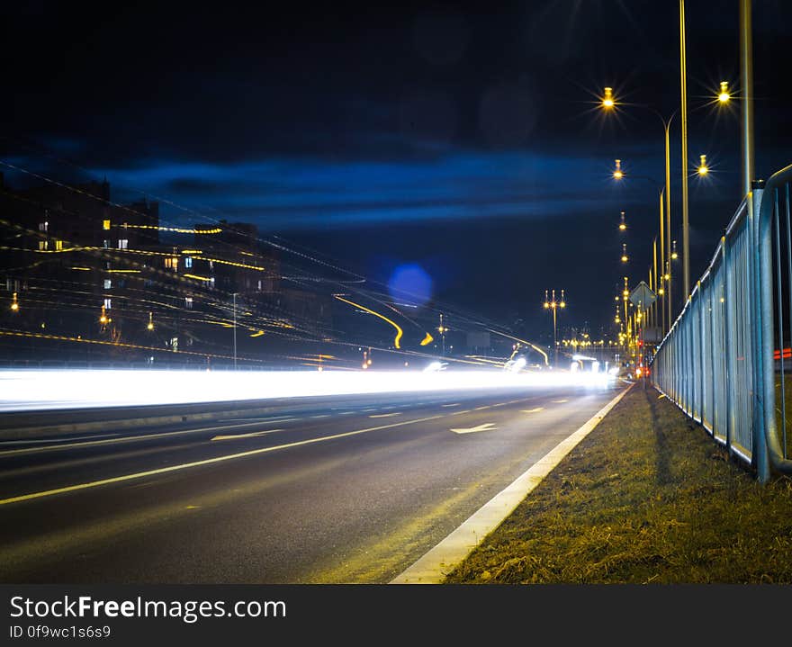 Blur of car headlights on urban streets at night. Blur of car headlights on urban streets at night.