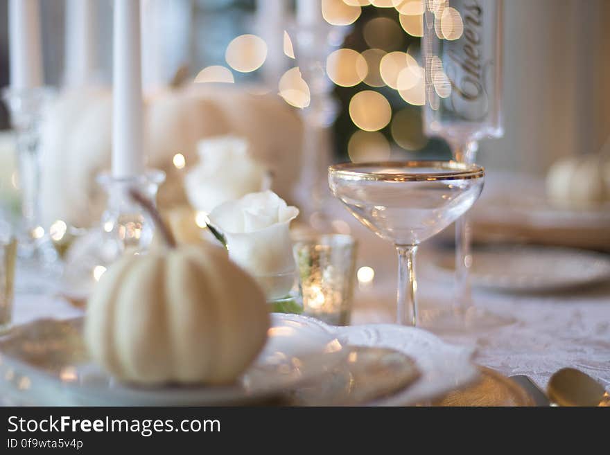 A close up of elegant table setting and decorative garlic on a ceramic saucer.