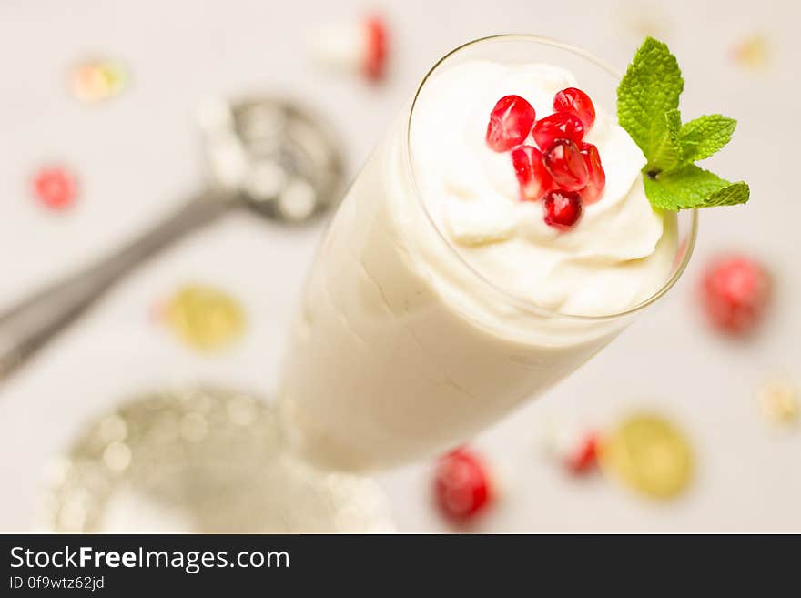 Elevated view of delicious yogurt in a glass topped with cherries. Elevated view of delicious yogurt in a glass topped with cherries.