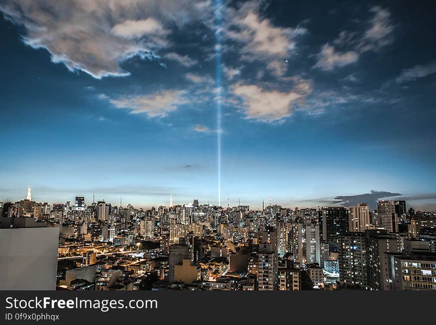 Cityscape Against Cloudy Sky