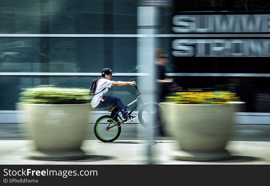 Man Riding Bicycle in City