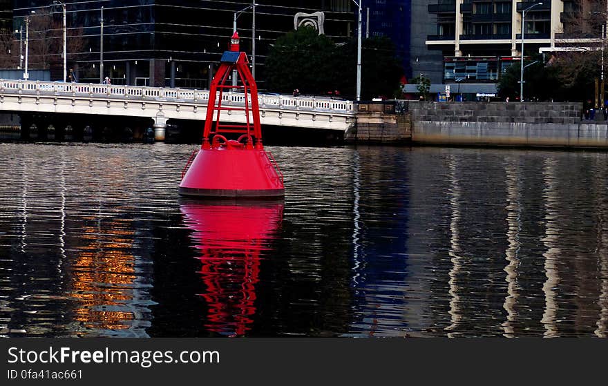 A Nun Buoy marks the Left side of the channel leaving the harbor. It will be red and have even numbers on it. Red Daymarkers are often used in shallow areas for the same purpose.. If the red marker has pilings supporting it, it will be called a dolphin. Red buoys with lights will usually be found in deeper water. The light will be red. Larger buoys may also have bells, horns or other sound producing devices. A Nun Buoy marks the Left side of the channel leaving the harbor. It will be red and have even numbers on it. Red Daymarkers are often used in shallow areas for the same purpose.. If the red marker has pilings supporting it, it will be called a dolphin. Red buoys with lights will usually be found in deeper water. The light will be red. Larger buoys may also have bells, horns or other sound producing devices.