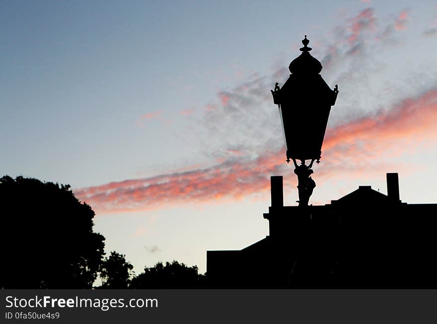 Silhouette of Street Lamp Under Clouds