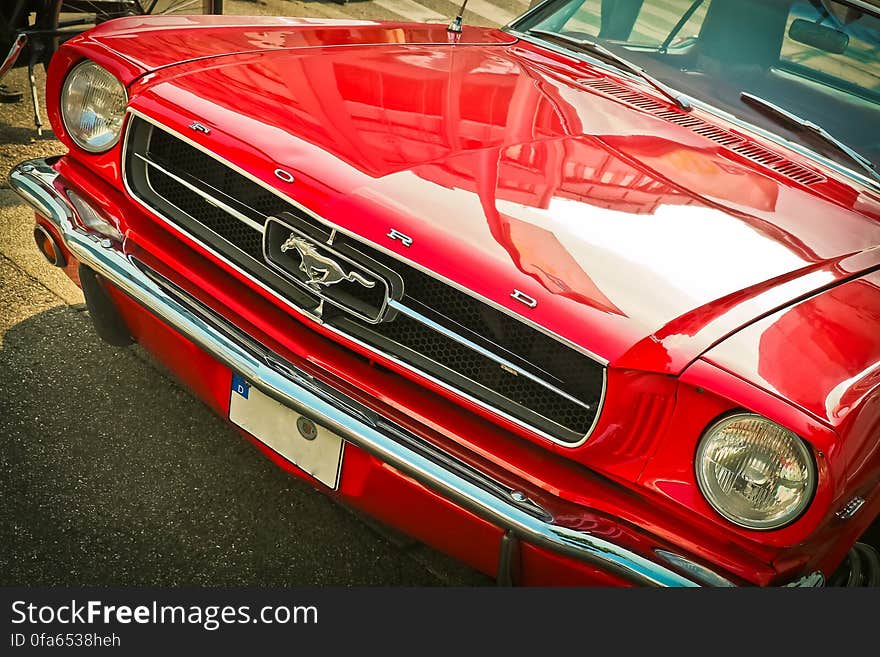 Front of a red vintage mustang motor car.