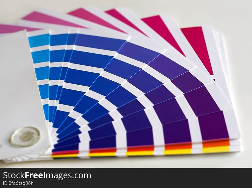 Fan of color samples in blue, purple, red and yellow.