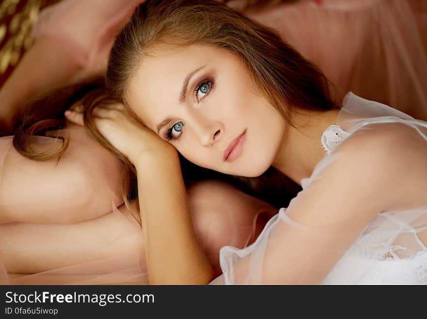 Portrait of beautiful young woman resting head on bare legs of partner.