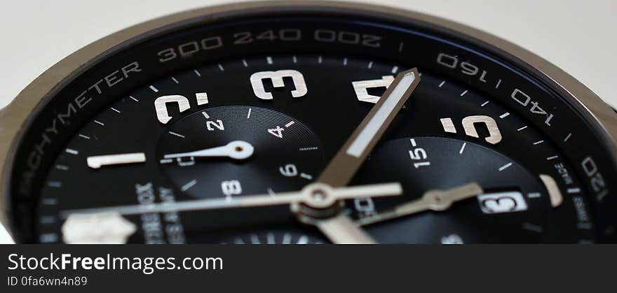 A close up of a chronograph watch on a white background.