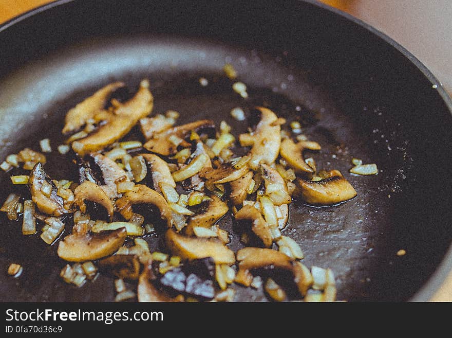 Closeup of onions and mushroom cooking in frying pan. Closeup of onions and mushroom cooking in frying pan.