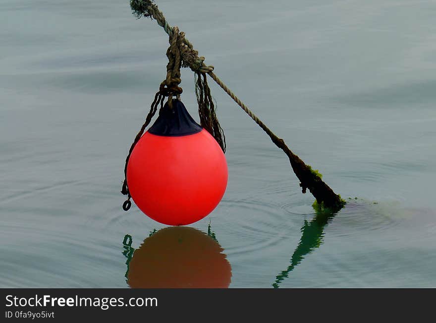 A buoy is a floating device that can have many purposes. It can be anchored &#x28;stationary&#x29; or allowed to drift with the sea wave. The word, of Old French or Middle Dutch origin, is &#x28;in UK English&#x29; now most commonly pronounced /ˈbɔɪ/ &#x28;identical with boy, as in buoyancy&#x29;. In American English the pronunciation is closer to &#x22;boo-ee.&#x22;. A buoy is a floating device that can have many purposes. It can be anchored &#x28;stationary&#x29; or allowed to drift with the sea wave. The word, of Old French or Middle Dutch origin, is &#x28;in UK English&#x29; now most commonly pronounced /ˈbɔɪ/ &#x28;identical with boy, as in buoyancy&#x29;. In American English the pronunciation is closer to &#x22;boo-ee.&#x22;