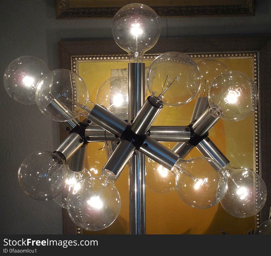 An artistic light stand with clear bulbs.