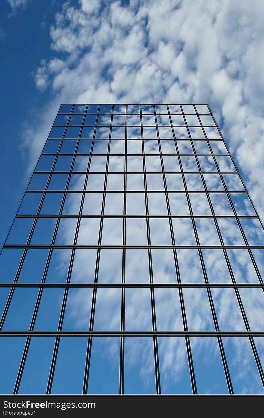 A low angle view of a glass skyscraper. A low angle view of a glass skyscraper.