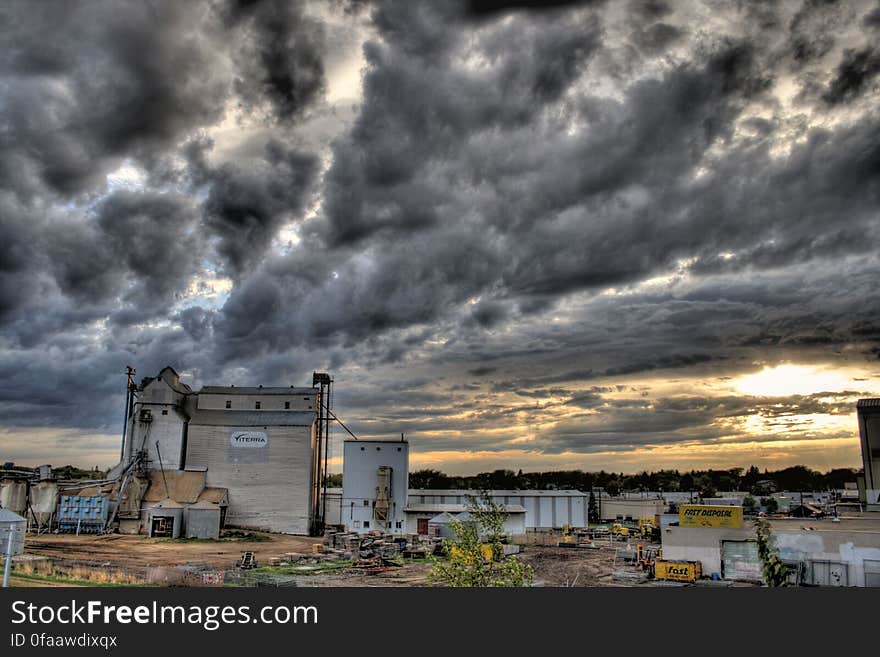 Exterior of farm structures in rural field against stormy skies. Exterior of farm structures in rural field against stormy skies.