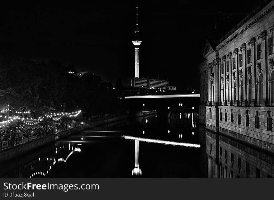 A black and white photo of Alexanderplatz in Berlin by night.