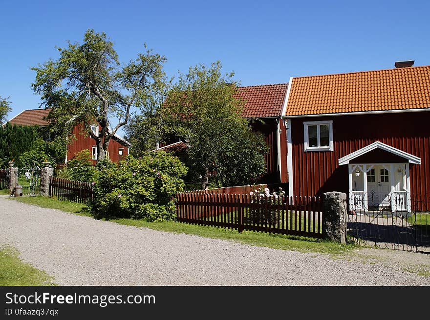 A row of neat bungalows along a street. A row of neat bungalows along a street.