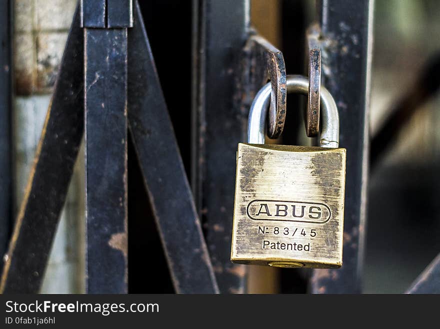 ABUS padlock on black metal door grate. ABUS padlock on black metal door grate.