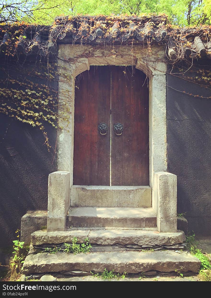 Concrete staircase leading to an old wooden door. Concrete staircase leading to an old wooden door.