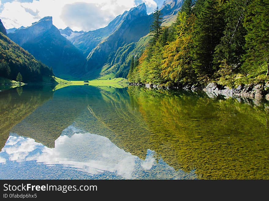 A lake in a valley in the middle of green mountains. A lake in a valley in the middle of green mountains.