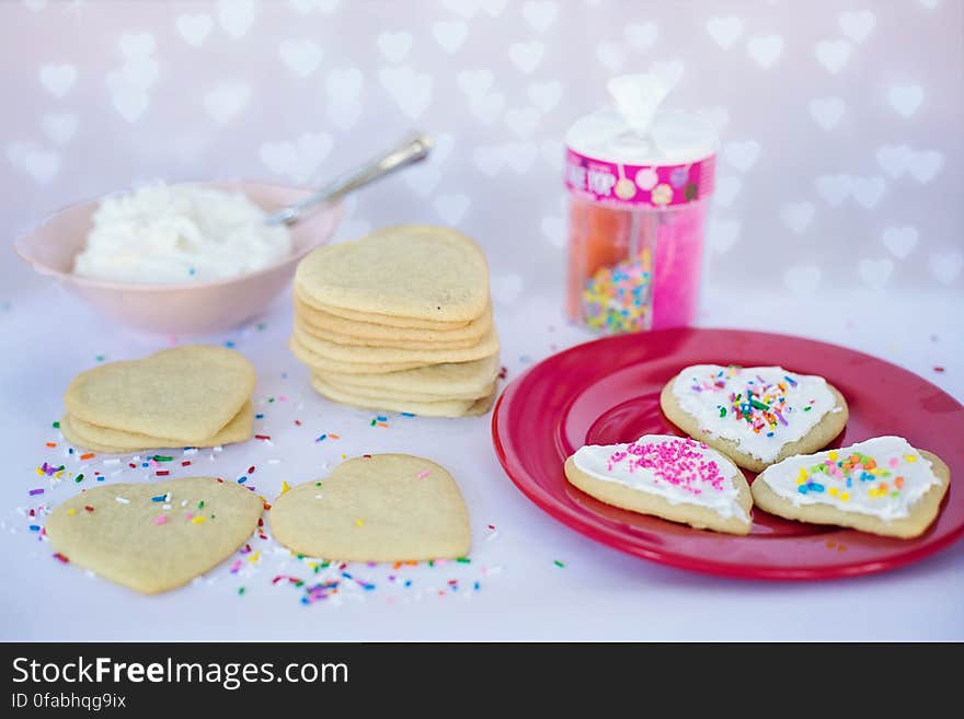 Homemade love heart biscuits with baking ingredients.