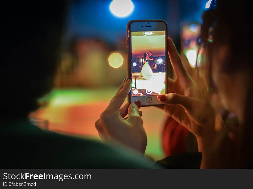 Close-up of Woman Using Mobile Phone at Night