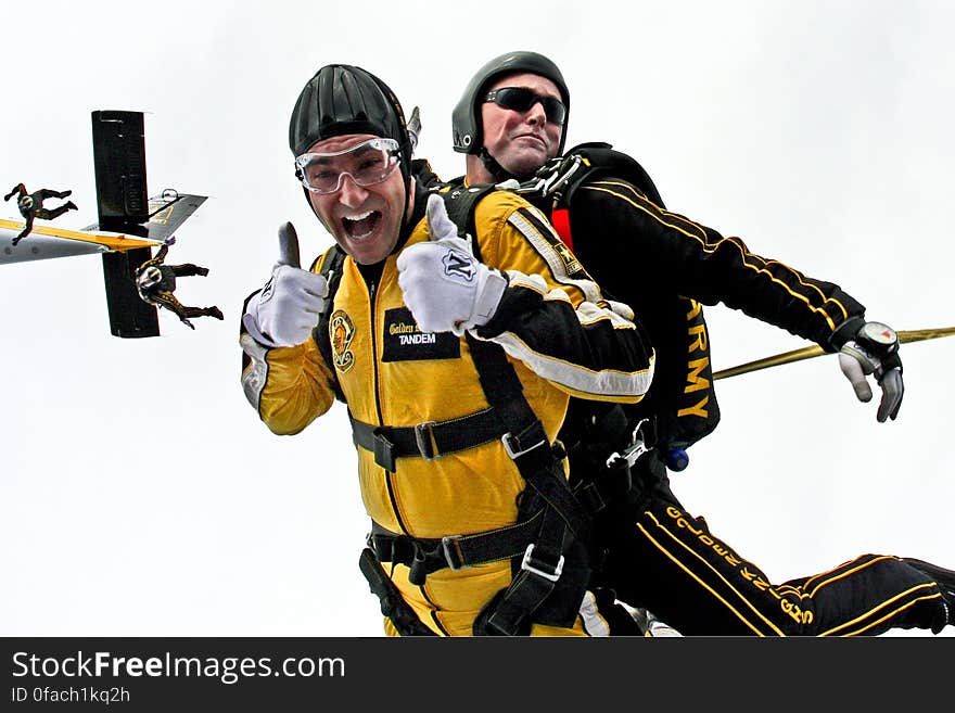 Man in Yellow Jumpsuit and Man in Black Jumpsuit Sky Diving