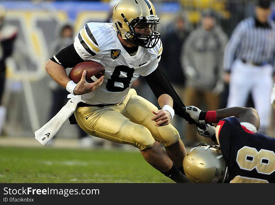 Man in Black Jersey Holding Jersey Number 8 With Ball