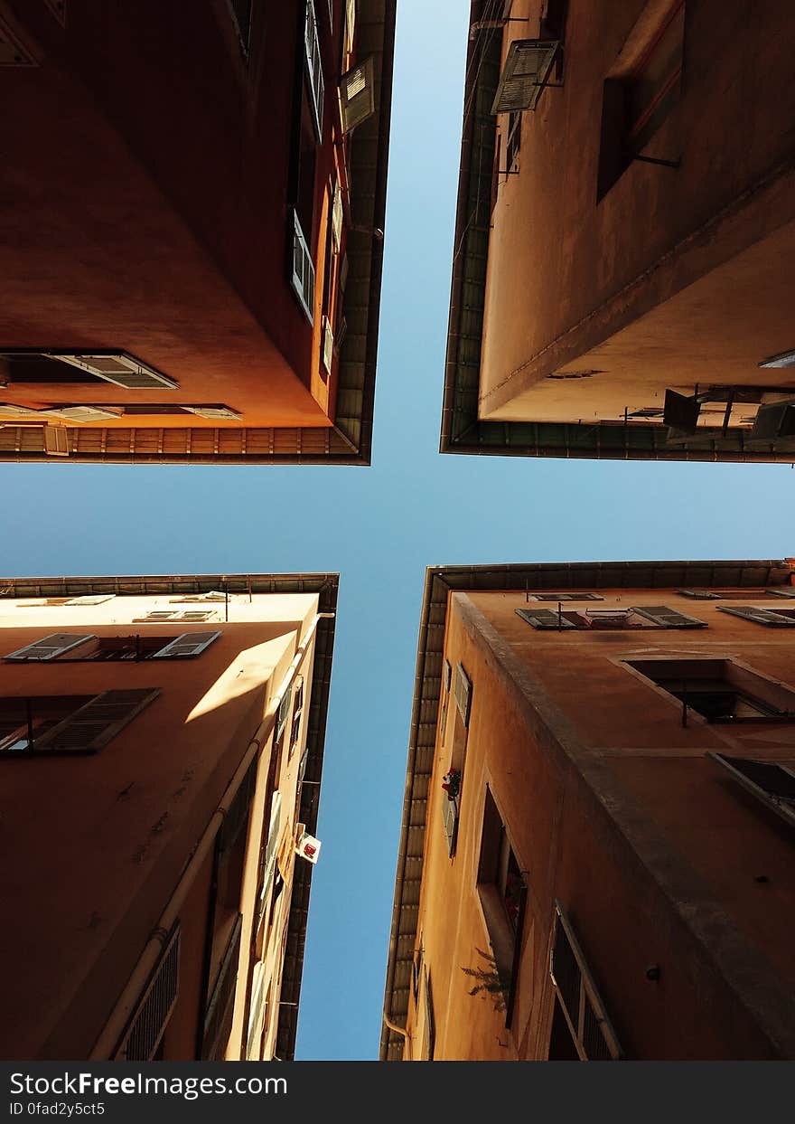 Worms Eye View of 4 Brown Concrete Buildings at Daytime