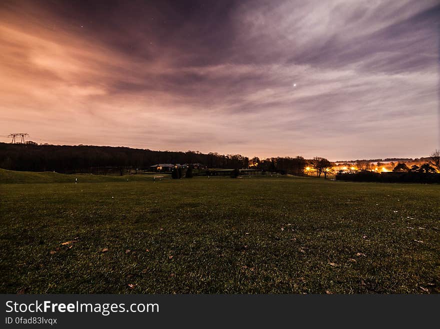 Green Field Under Cloudy Sky during Daytime