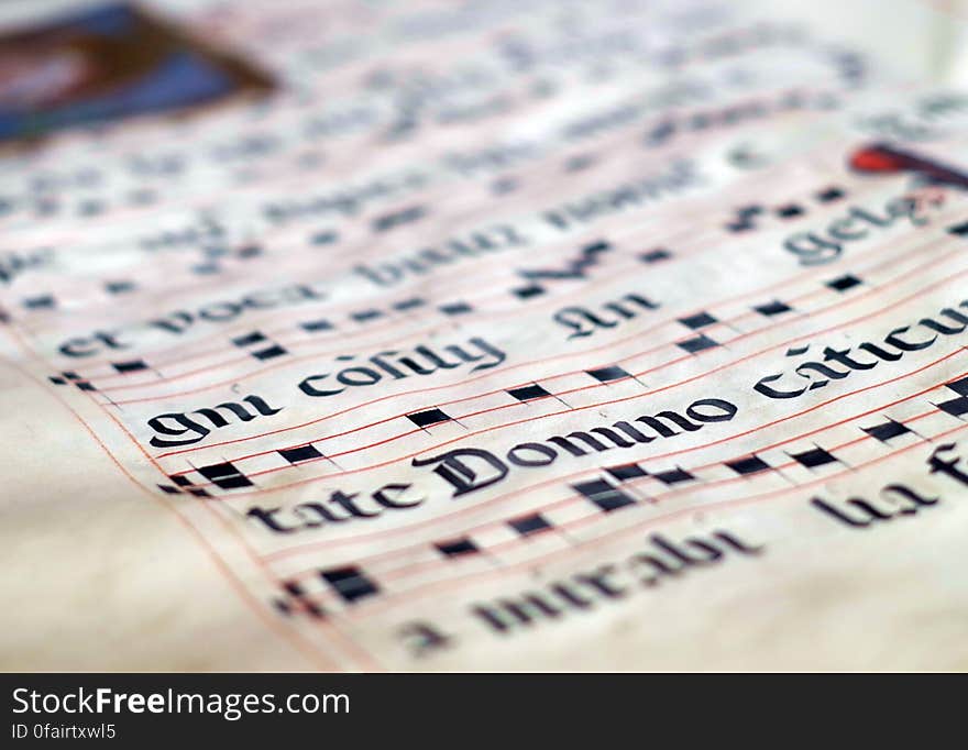 Close up of medieval musical score on antique parchment paper.