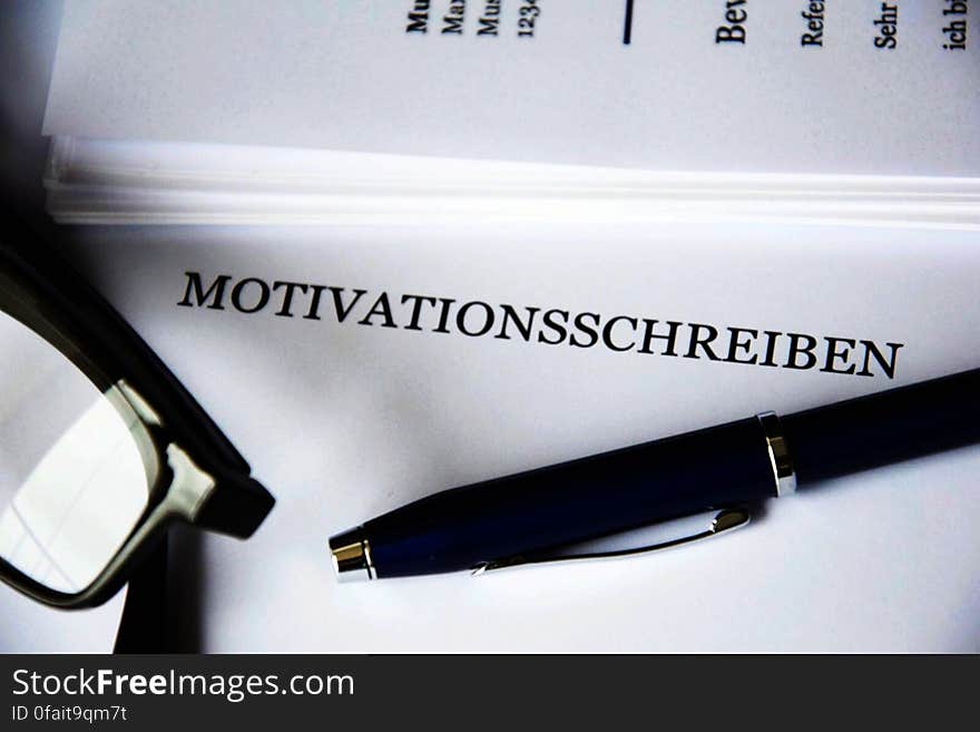 Close up of business document with eyeglasses and writing pen. Close up of business document with eyeglasses and writing pen.